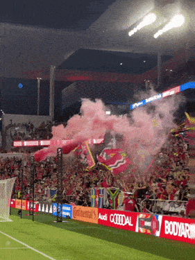 a soccer stadium with a banner that says audi on it