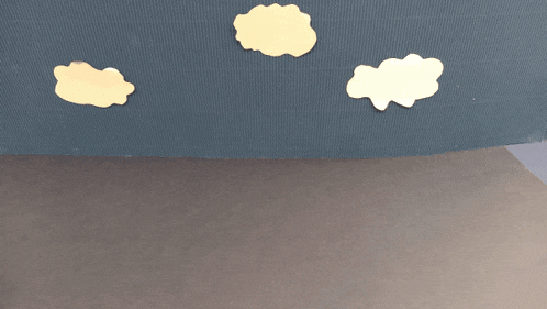 a toy truck is sitting on the ground with a blue wall in the background