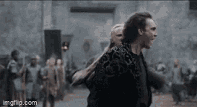 a man and a woman are standing next to each other in a crowd of people .