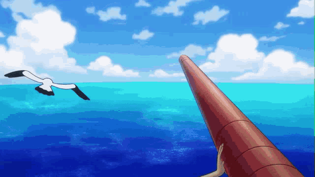 a seagull is flying over a body of water with a red pipe in the foreground