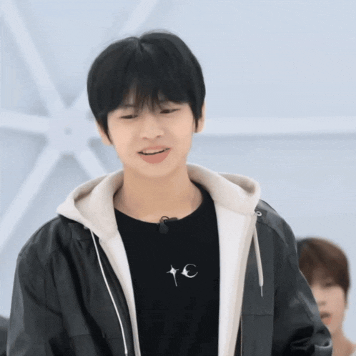 a young man wearing a black t-shirt that says tc