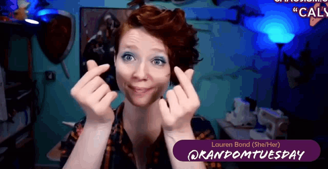 a woman making a heart shape with her fingers and the name lauren bond is on the bottom