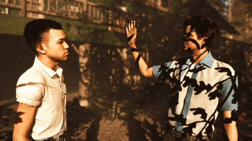 a man giving another man a high five in front of a sign that says ' king '