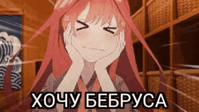 a girl with red hair is making a funny face with her hands on her face in a room .