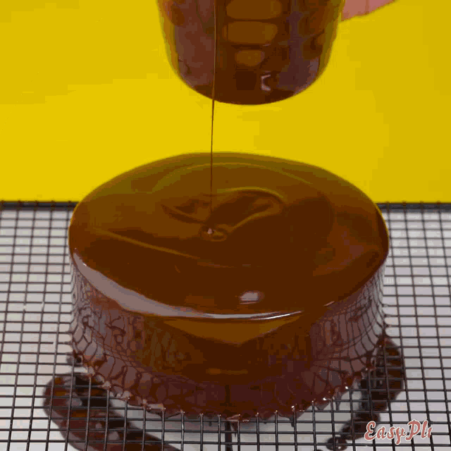 a cake is being glazed with chocolate and the words easy pie are visible