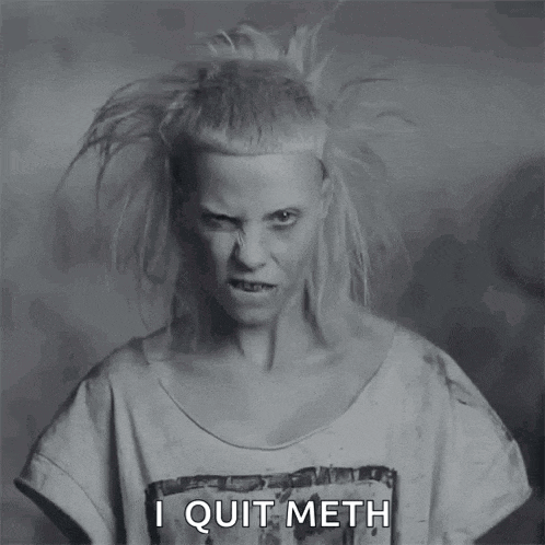 a black and white photo of a woman with a shirt that says i quit meth