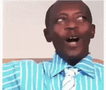 a man wearing a blue striped shirt and tie is making a funny face