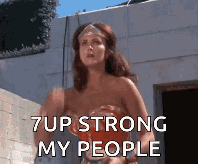 a woman in a wonder woman costume is saying 7 up strong my people .