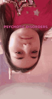 a girl is upside down with the words psychotic disorders written above her head .