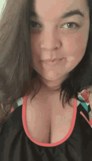 a close up of a woman 's face with her breasts showing