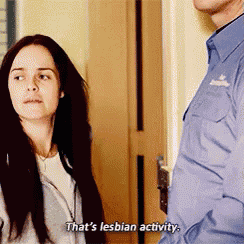 a man and a woman are standing next to each other and the woman is saying that 's lesbian activity