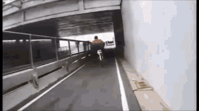 a man is riding a bike through a tunnel