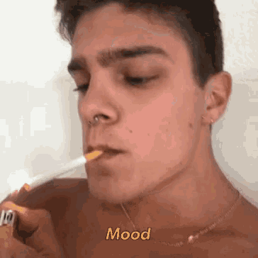 a shirtless man is lighting a cigarette with a lighter and the word mood is above him .
