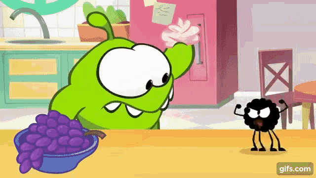 a cartoon character is standing next to a bowl of grapes .