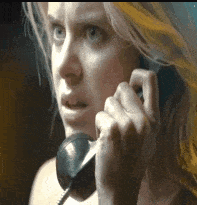 a close up of a woman talking on a telephone