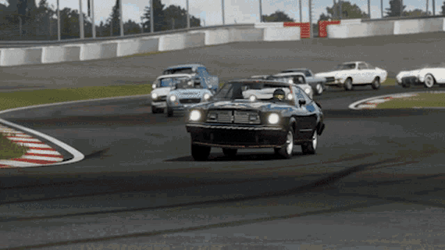 a group of cars are racing on a track and one of them has the word ford on the side