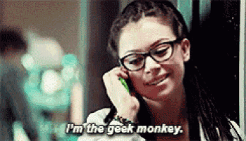 a woman wearing glasses is talking on a cell phone and says `` i 'm the geek monkey . ''