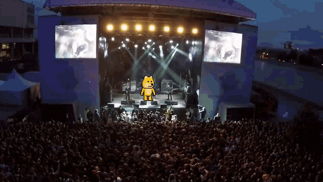 a crowd of people watching a band on stage