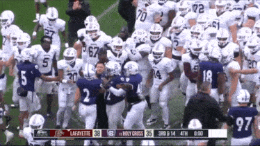 a football game between lafayette and holy cross is being played