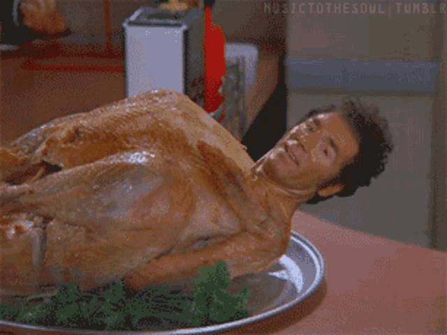 a man laying on top of a turkey on a plate with musictothesoul tumblr written on the bottom