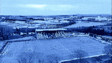 an aerial view of a soccer field with a stadium in the background that says ' esc '