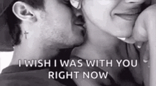 a man is kissing a woman on the cheek .