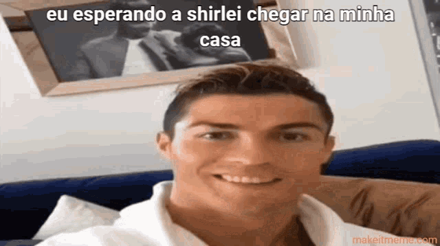 a man is sitting on a couch with a caption that says " eu esperando a shirlei chegar na minha casa "