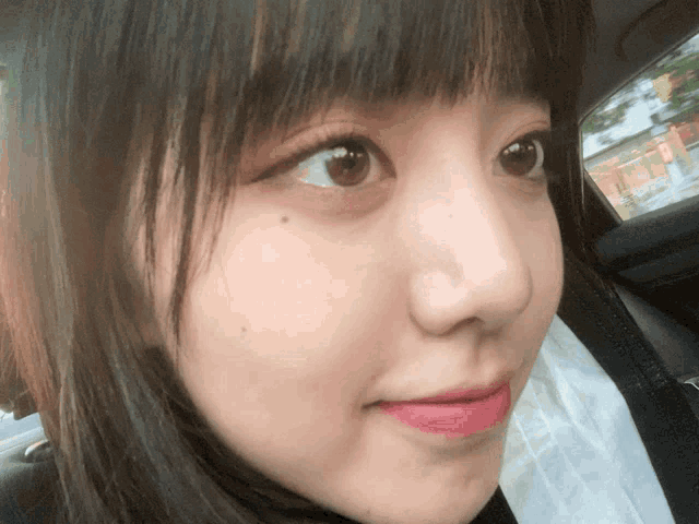 a close up of a girl 's face with a pink lipstick