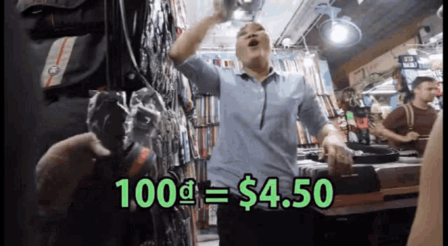 a man in a blue shirt is standing in front of a sign that says 100 dollars = $ 4.50