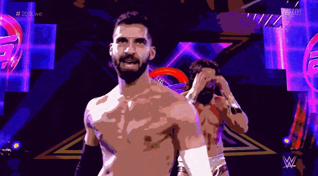 a shirtless wrestler is standing next to another wrestler in front of a sign that says # 20live