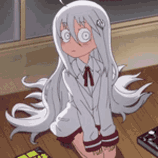 a girl with long white hair is sitting on the floor with her legs crossed .