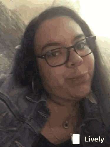 a woman wearing glasses and a denim jacket has a lively icon next to her face