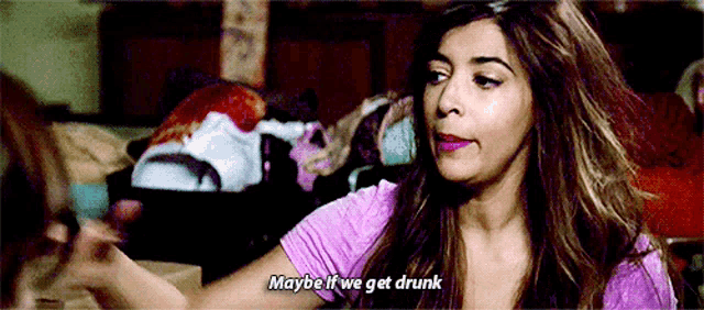 a woman in a purple shirt is talking to another woman and saying `` maybe it 's we get drunk '' .