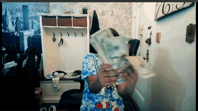 a person holding a bunch of money in front of a sign that says ' no '