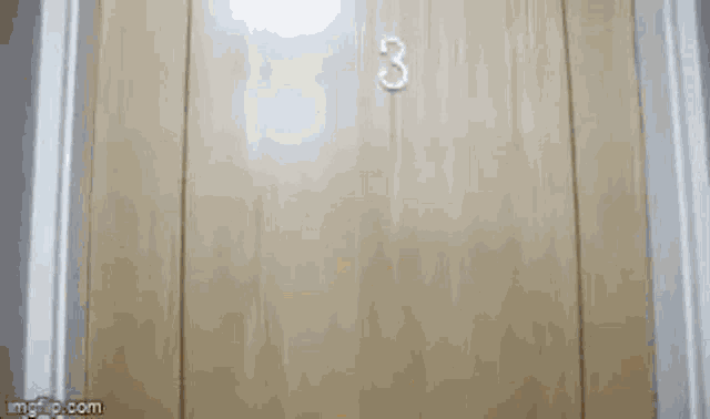 a close up of a door in a room with a light on the wall .