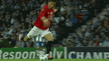 a soccer player in a red shirt with the number 9 on it kicks the ball