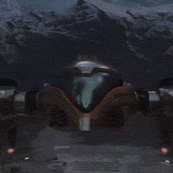 samus from the video game nintendo switch is standing in front of a mountain holding a gun .