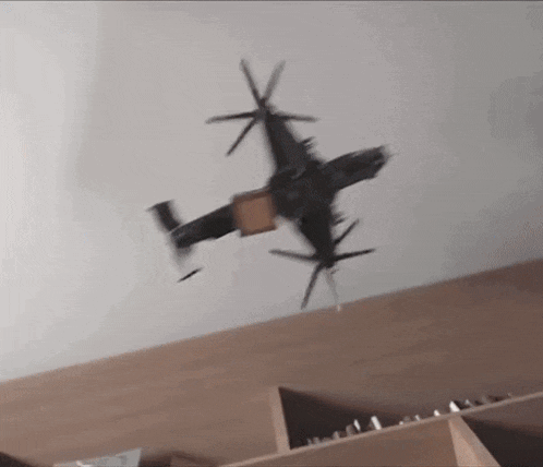 a model airplane is flying over a wooden shelf .