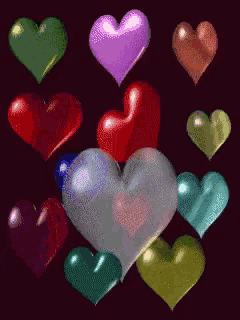 a bunch of different colored hearts are on a black background