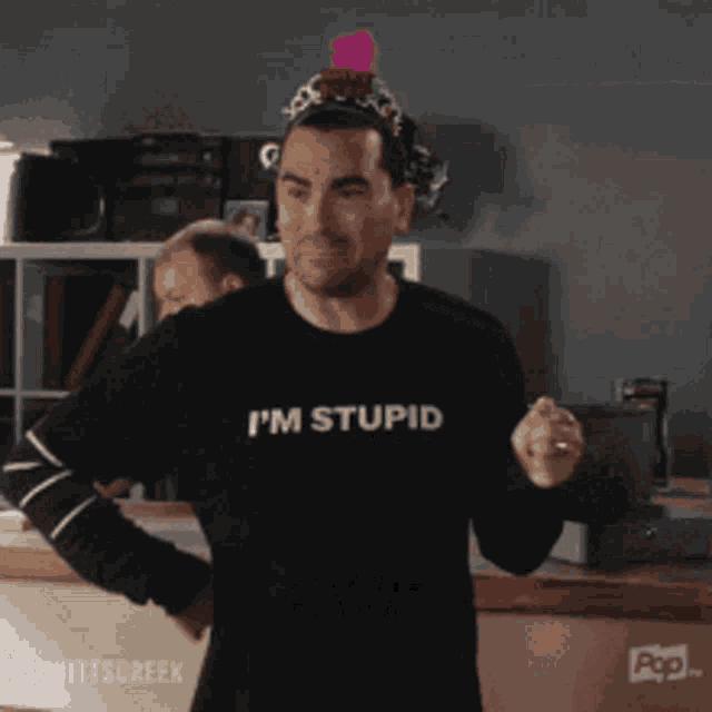 a man wearing a t-shirt that says i 'm stupid