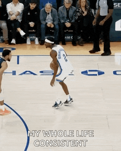a basketball player is dribbling a ball on a court and says my whole life consistent .