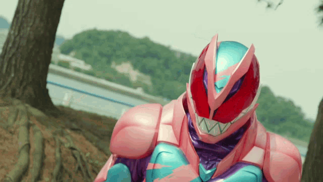 a pink and purple robot is standing in front of a tree