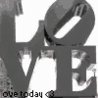 a black and white photo of a love sign on a table .