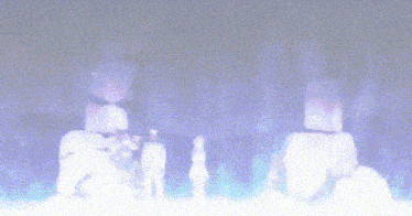 a blurred image of a group of people standing in a dark room