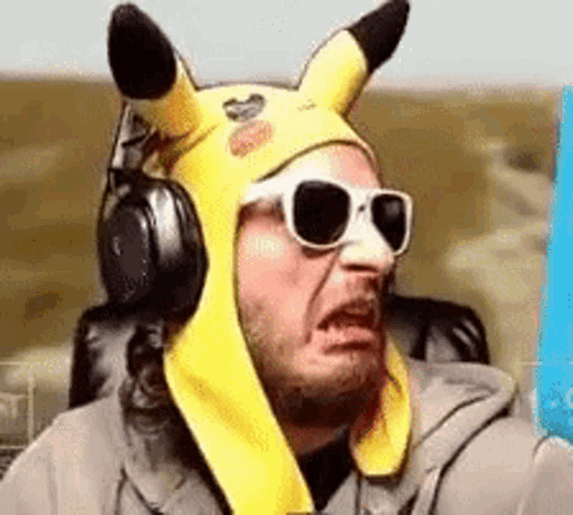 a man wearing a pikachu hat and sunglasses .