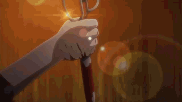 a person is holding a knife in their hand with a flame coming out of it