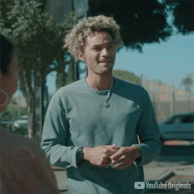 a man in a blue shirt is standing next to a woman in a youtube originals advertisement