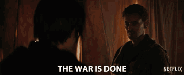 a man talking to another man with the words " the war is done " on the bottom