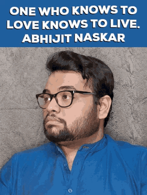a man wearing glasses and a blue shirt with the words one who knows to love knows to live behind him