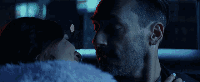 a man and a woman are kissing in the back seat of a car